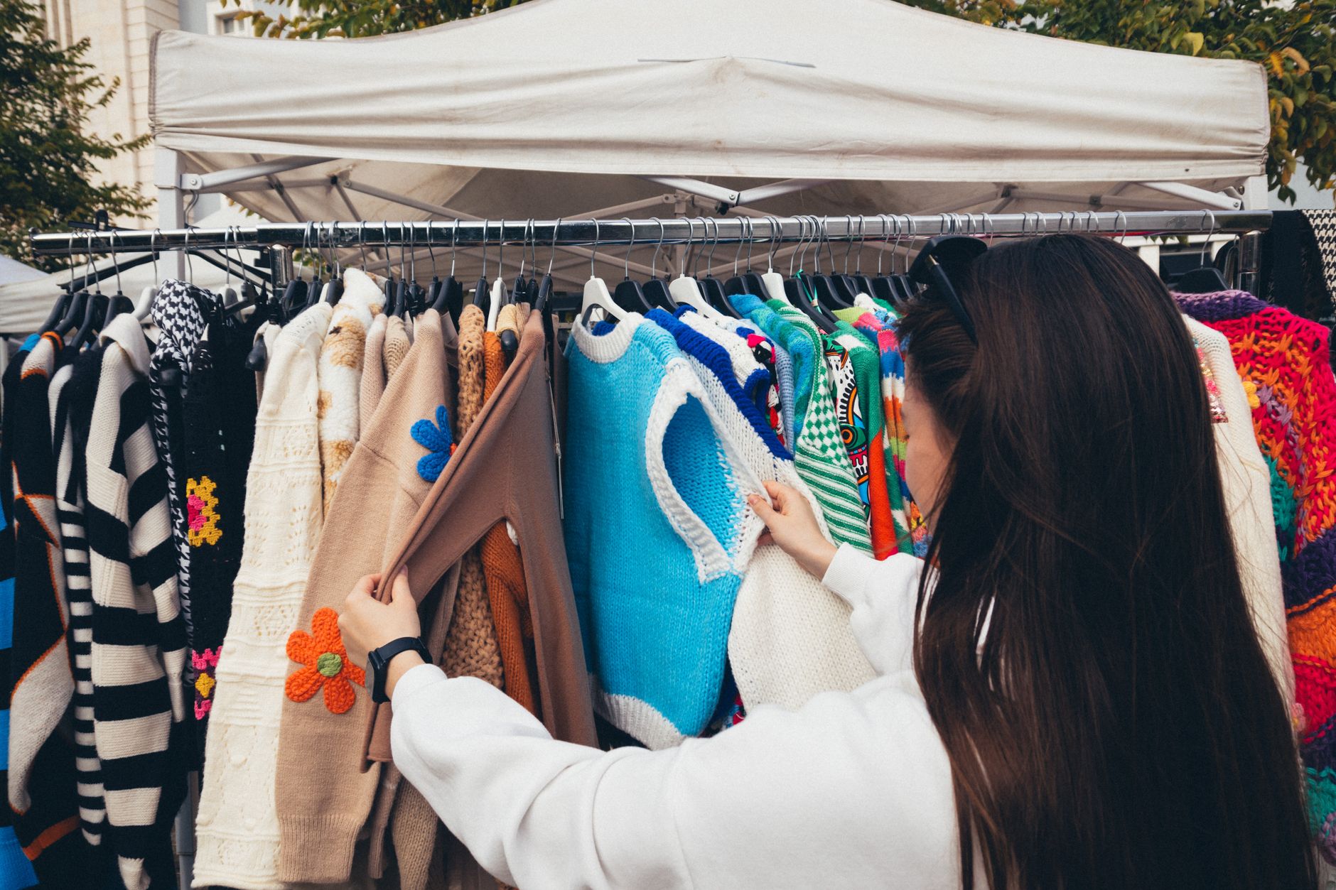 Close-up of pre-loved clothing on a curated vintage rail, typical of the new vintage clothing shops on UK high streets