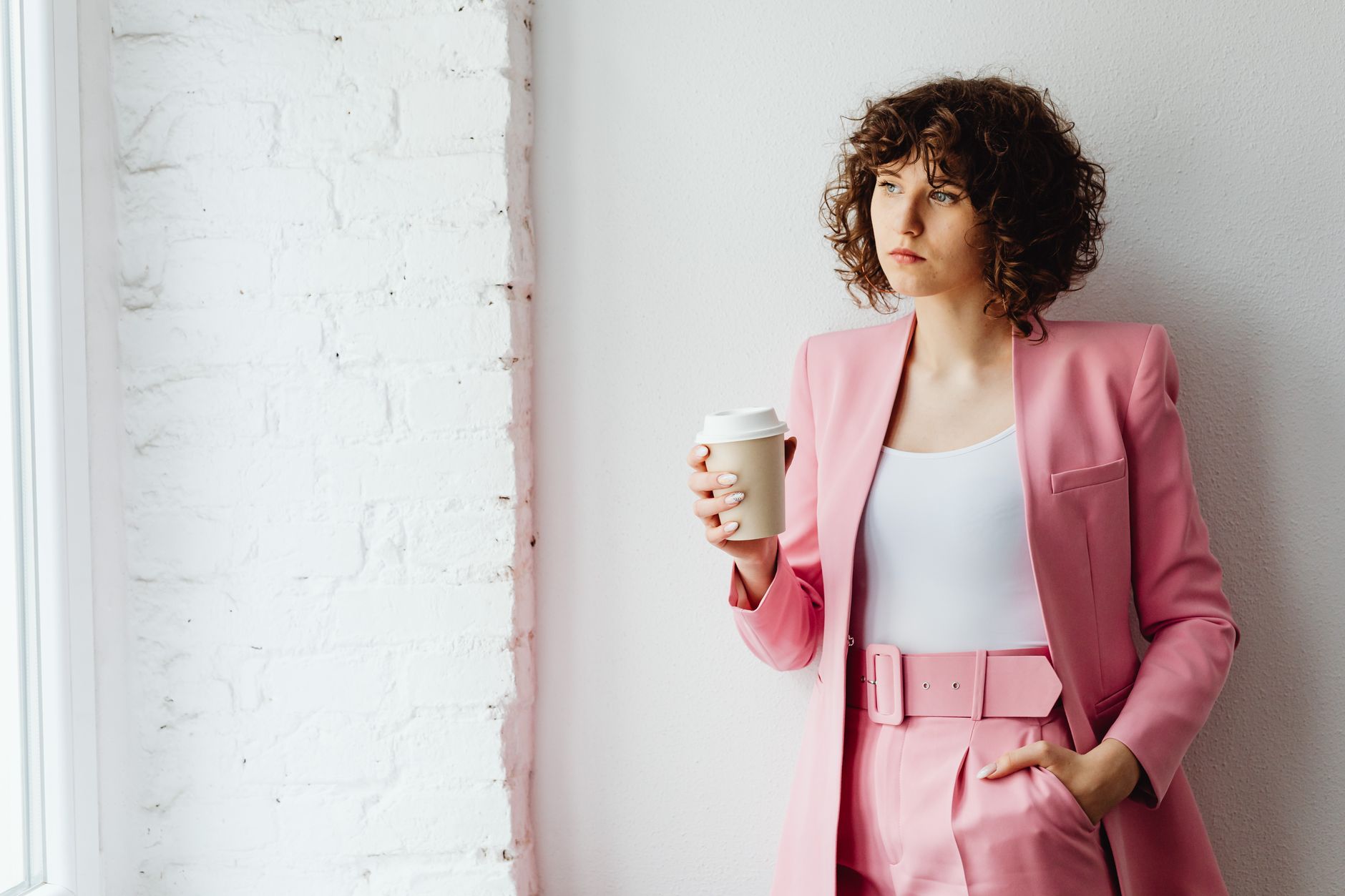 Professional woman in smart casual dress code UK office 2026 setting wearing tailored trousers and blazer