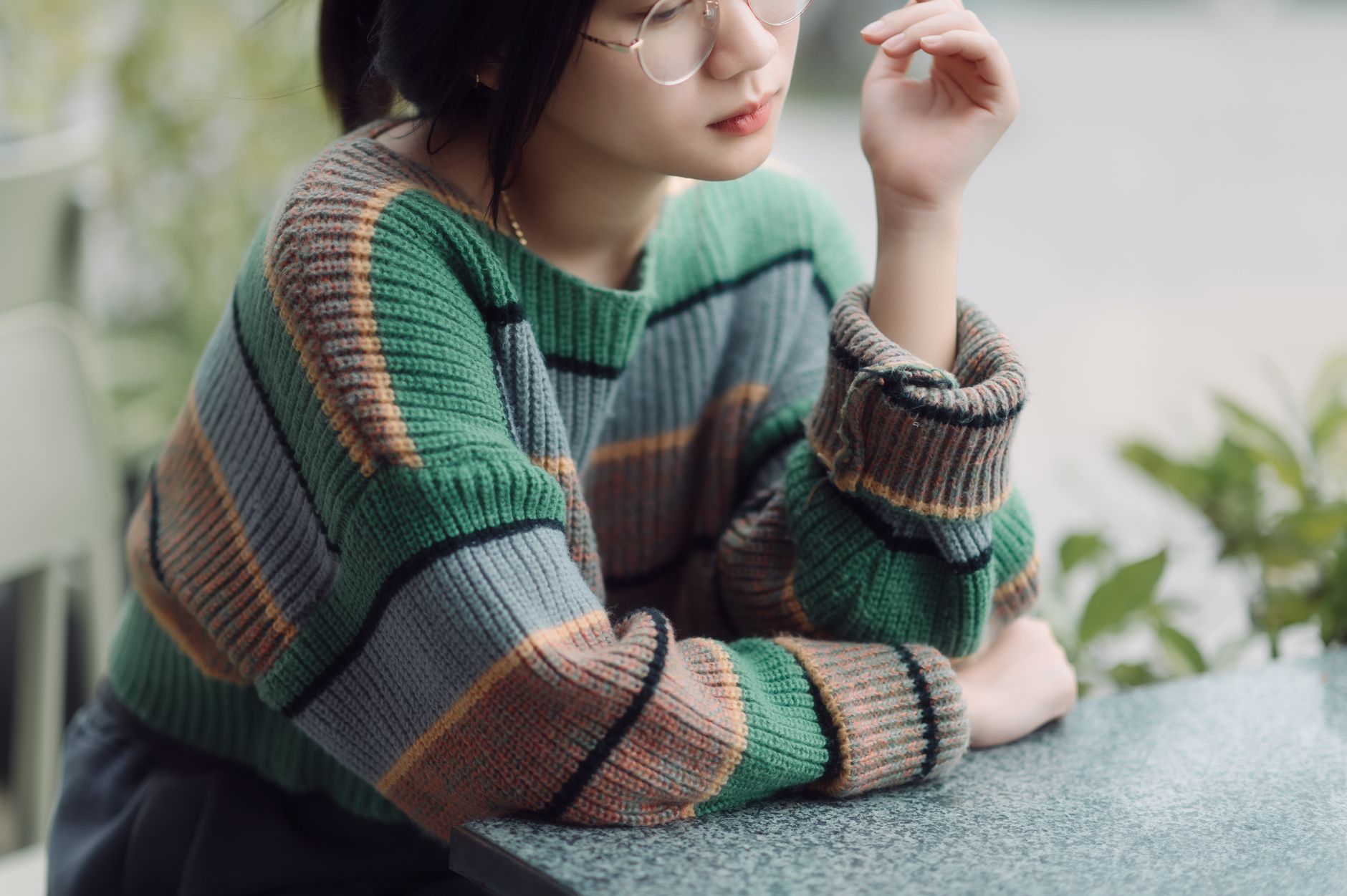 Woman in layered knitwear inspired by British soap fashion character styling
