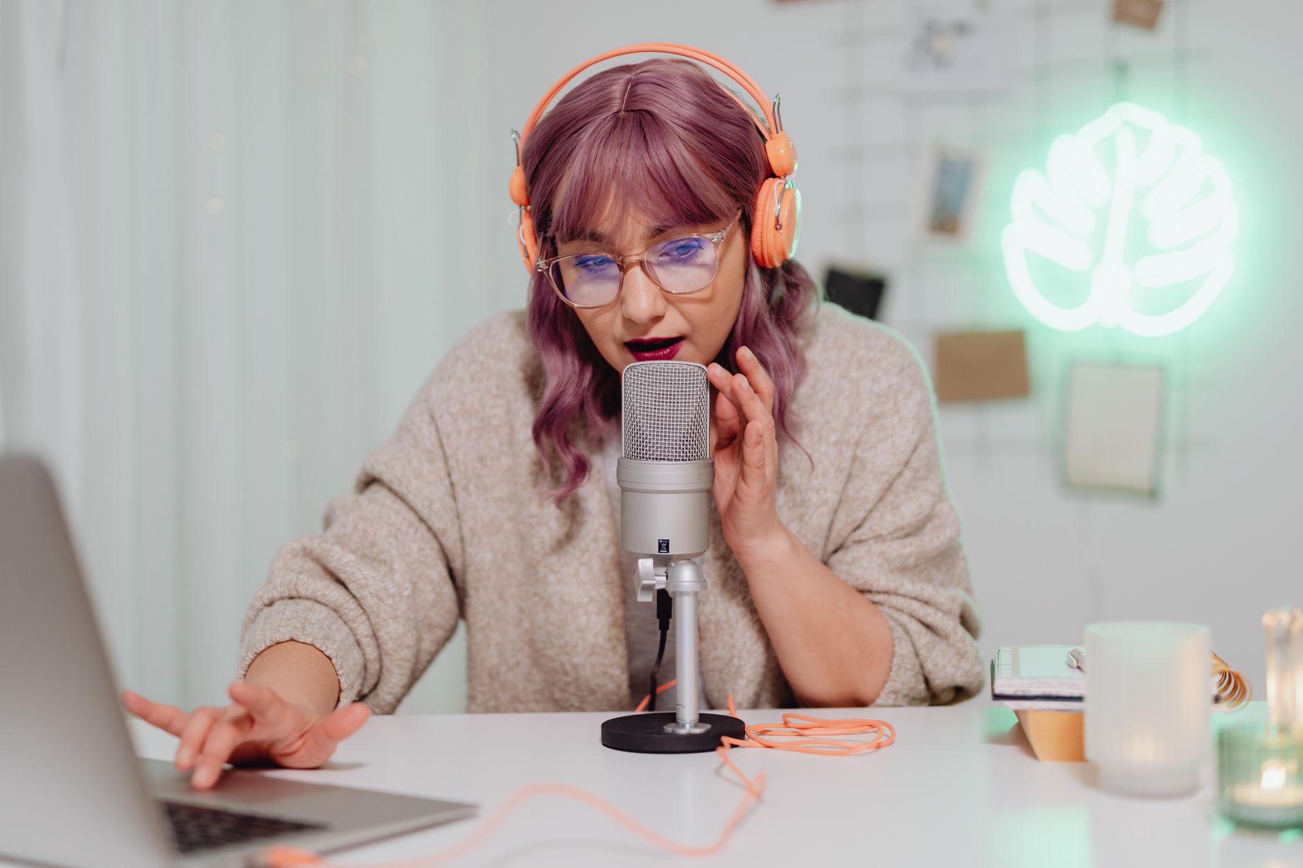 Woman recording a podcast episode, representing the social media and podcast landscape behind British celebrity feuds 2025